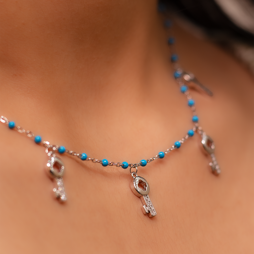 SILVER BLUE CRYSTAL WITH 5 KEY SYMBOL NECKLACE